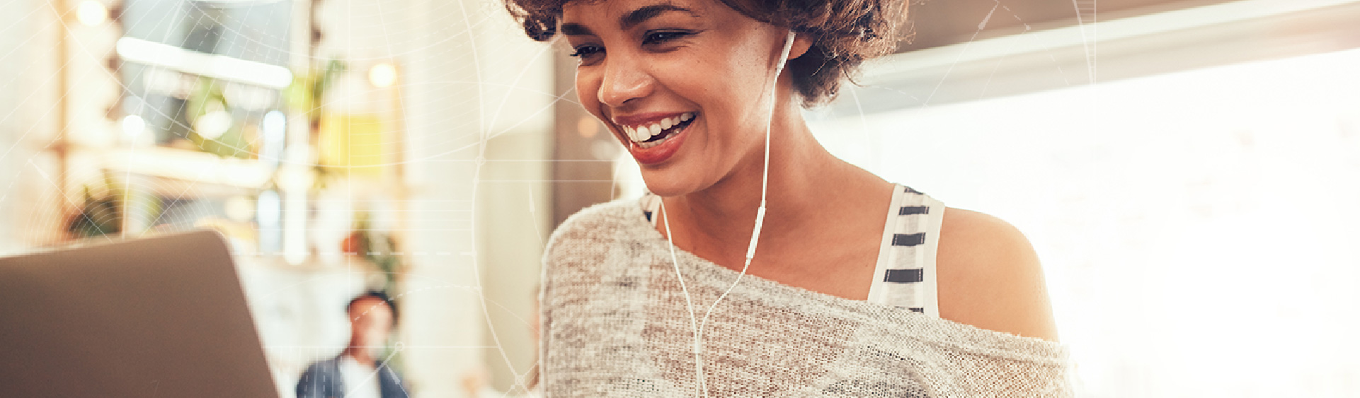 Young female college student smiling with ear buds in her ears.